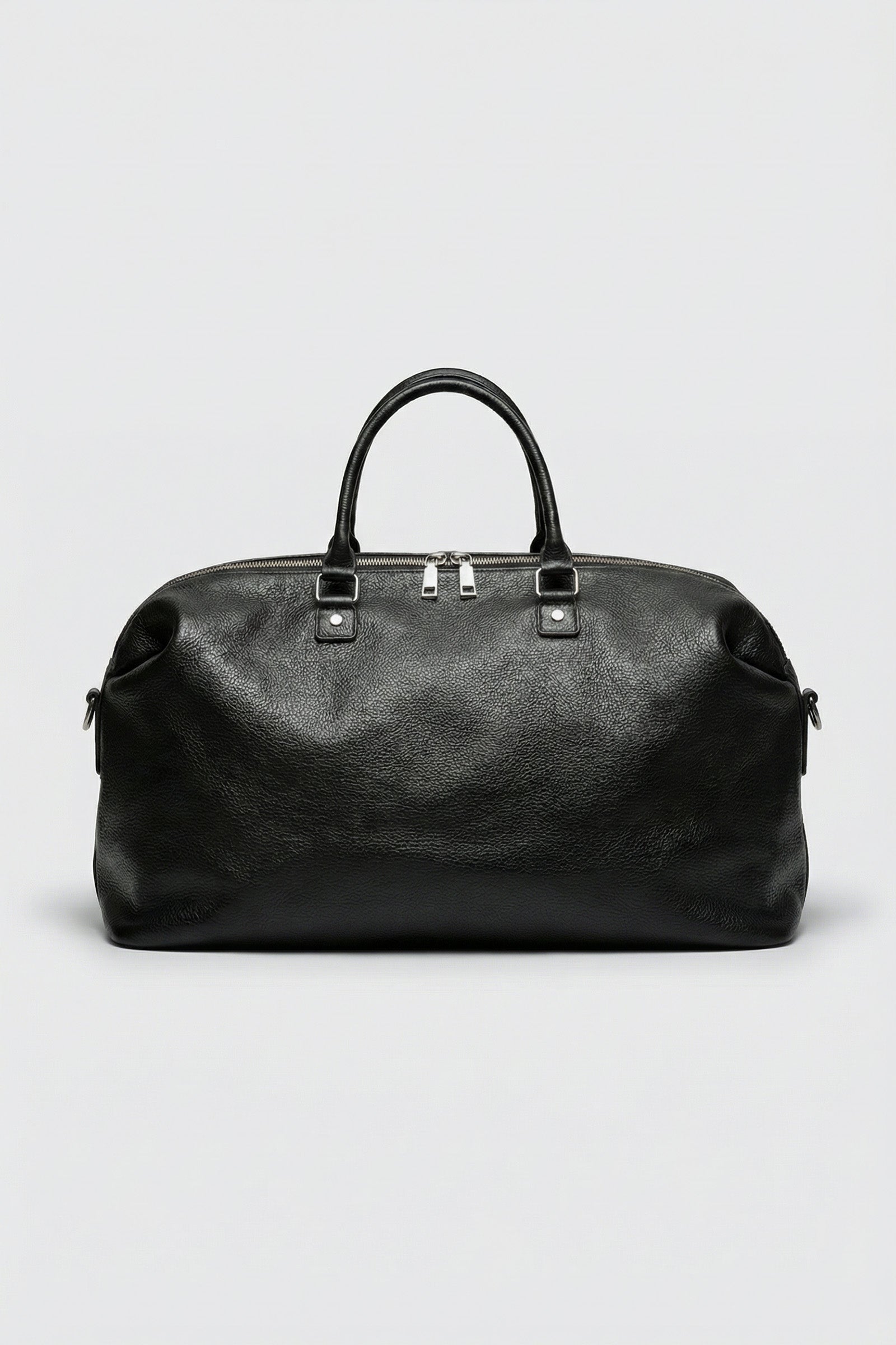 Top-grain luxury black leather executive duffle bag for business travel and gym use.