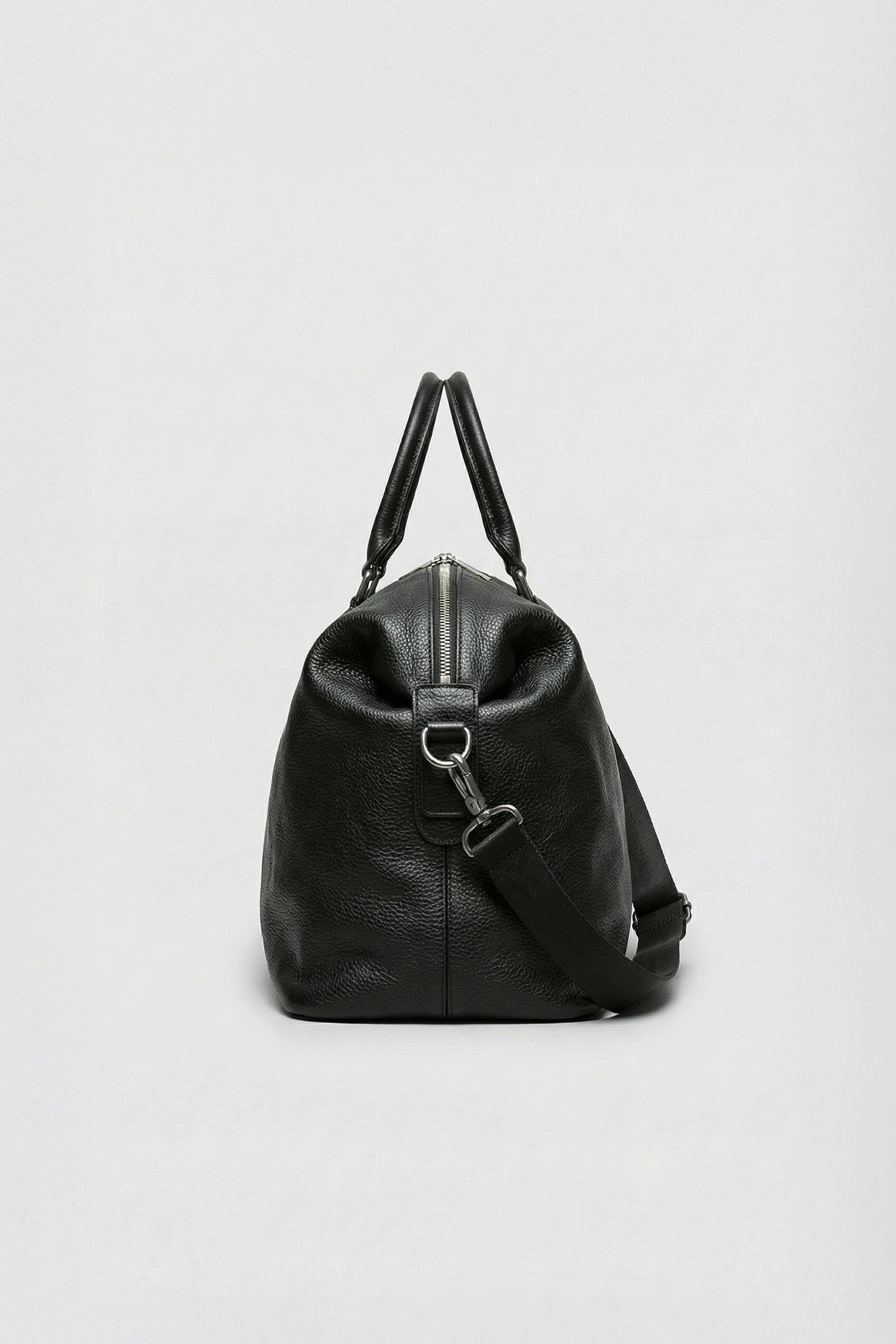 High-quality black leather overnight bag made from premium top-grain hide.